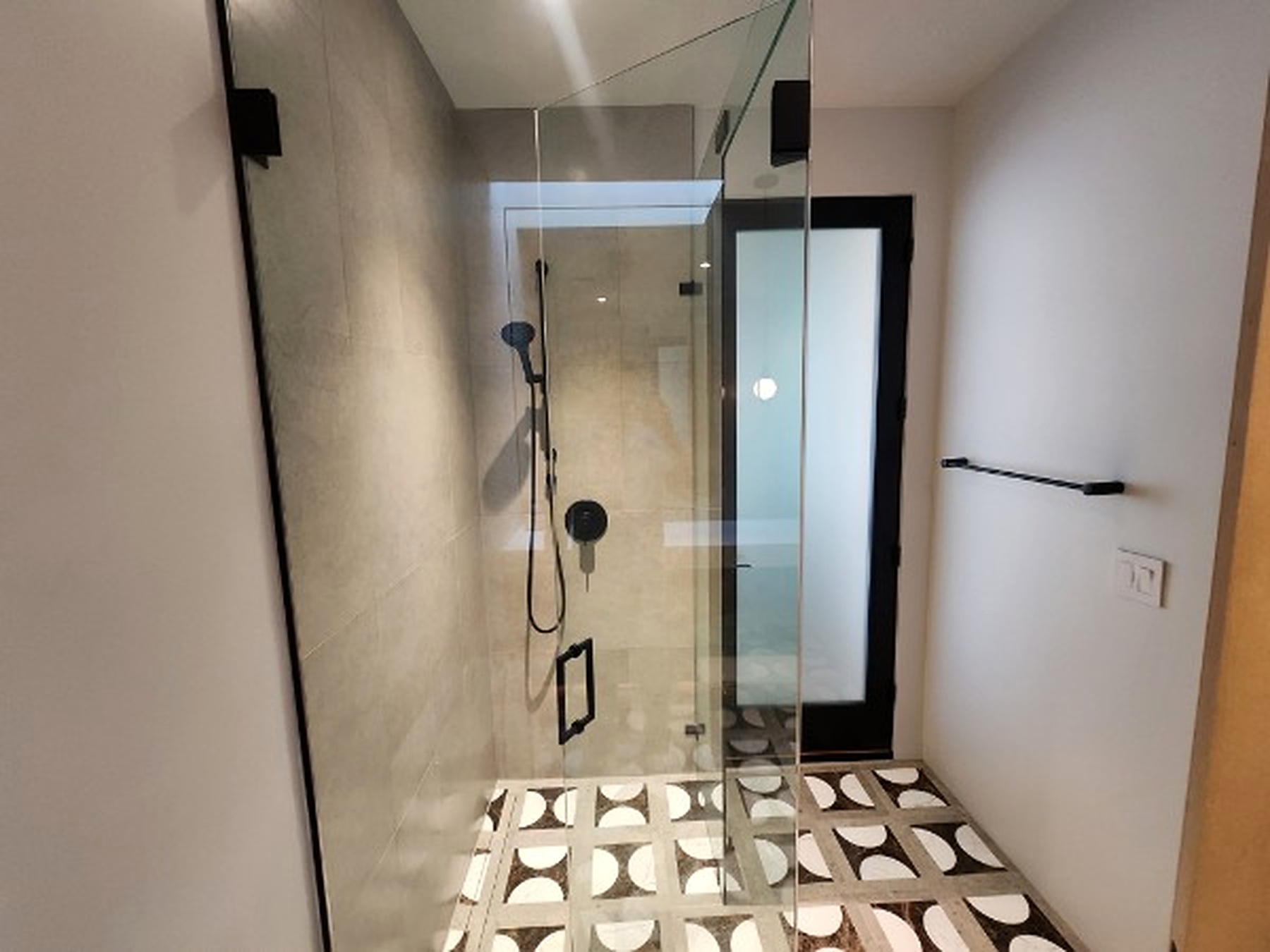 Glass shower and patterned floor
