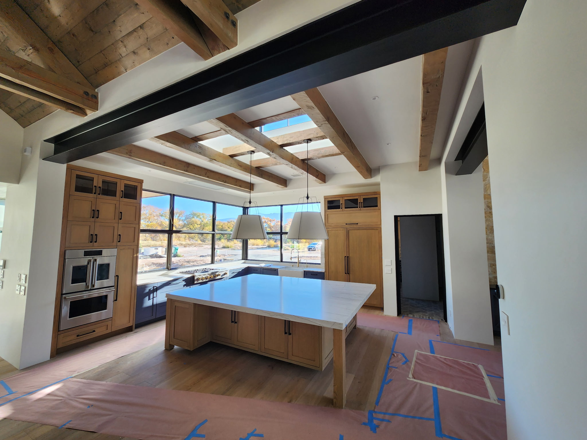 Kitchen during late-stage project work with floor protection
